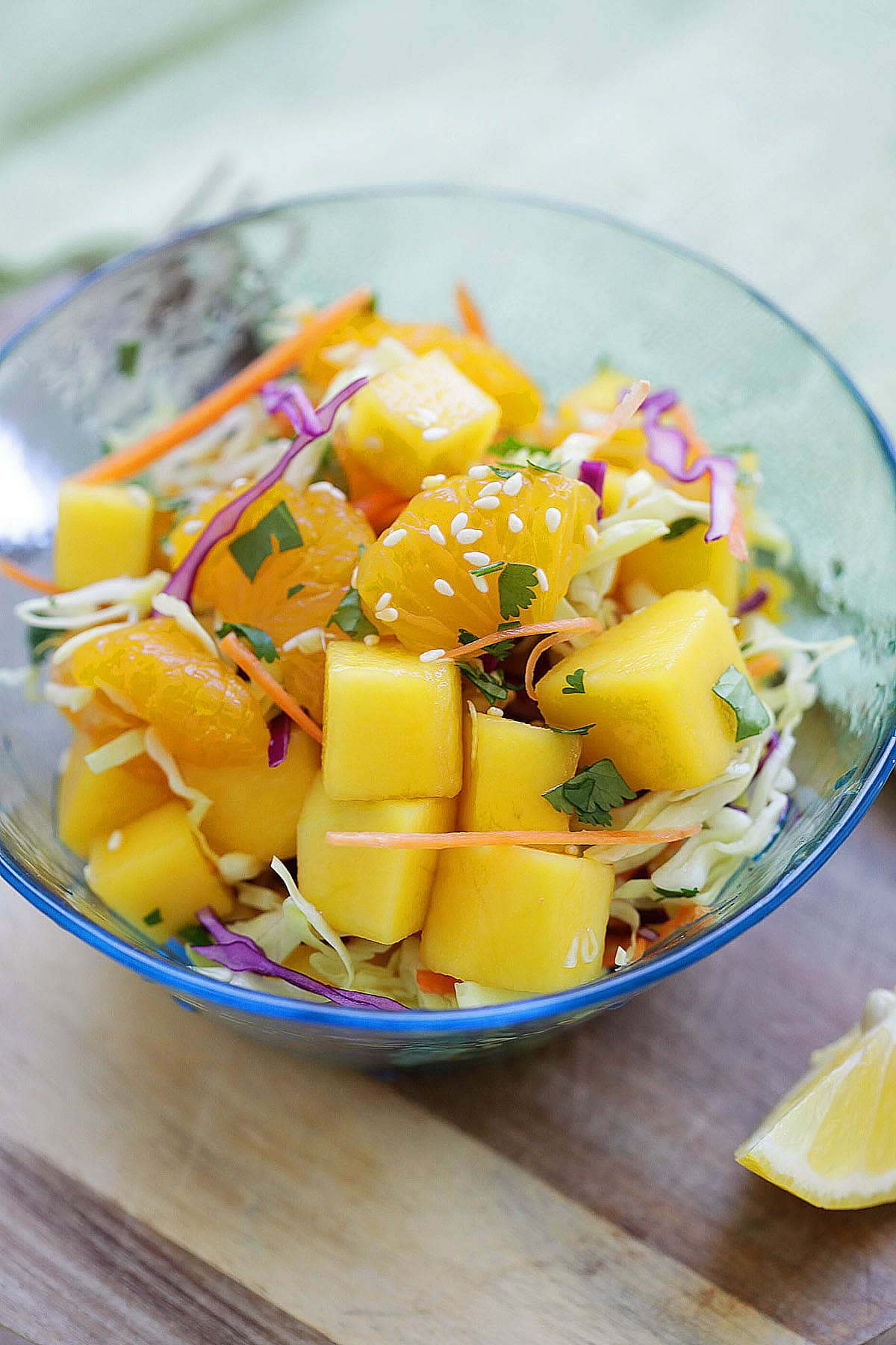 Tropical Asian fruit salad with mangoes and mandarin oranges served in a bowl.