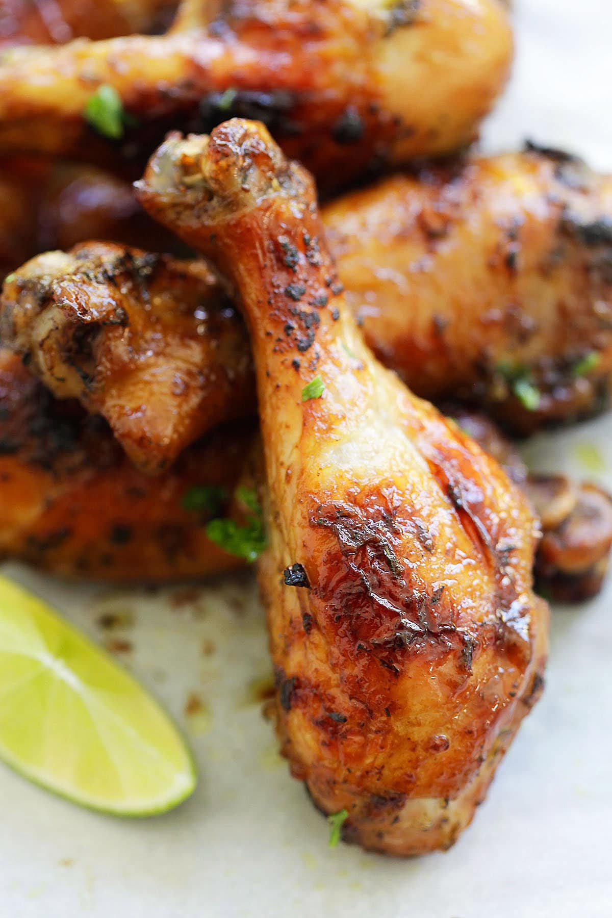 Grilled jerk chicken served with a lime wedge.