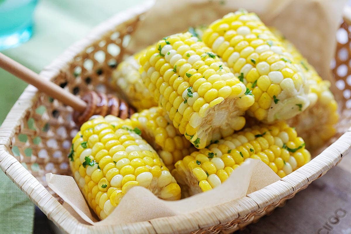 Freshly cooked honey butter corn stacked in a basket, an easy side dish for any meal.