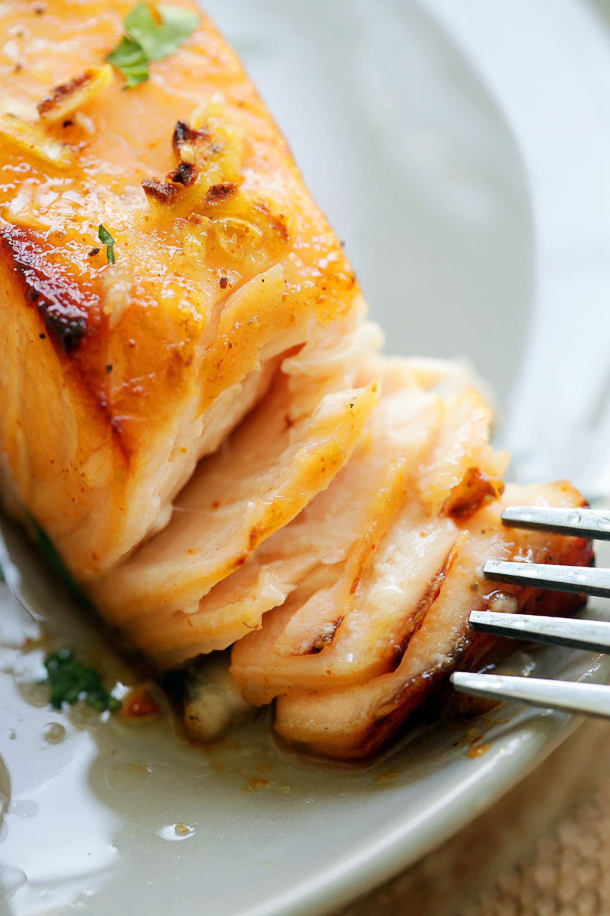 Flaky oven baked honey mustard salmon garnished with parsley.