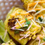 Easy grilled corn on the cob loaded with spicy mayo, shredded Parmesan, and chopped cilantro.