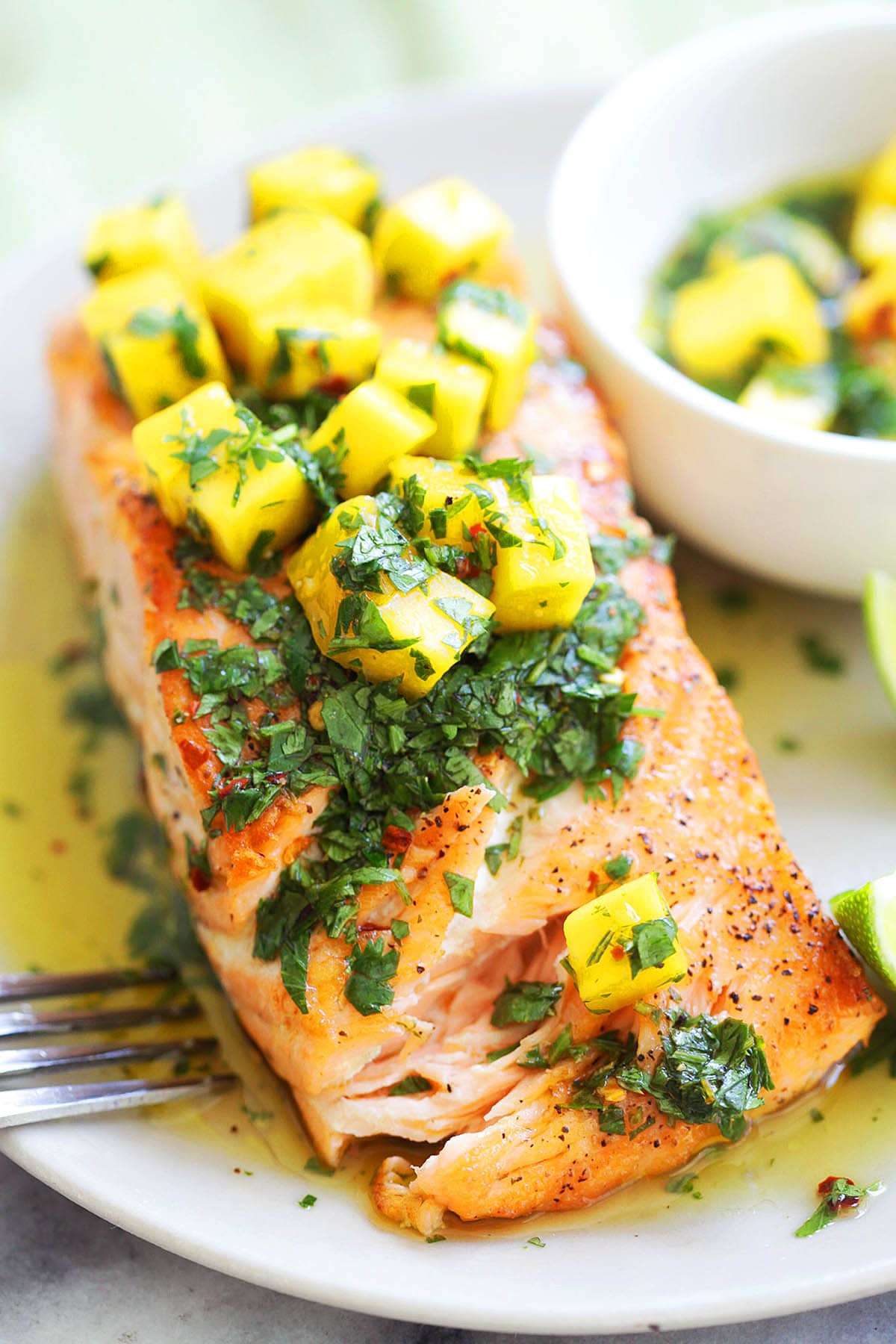 Easy grilled salmon with mango salsa recipe served with extra mango salsa on the side.