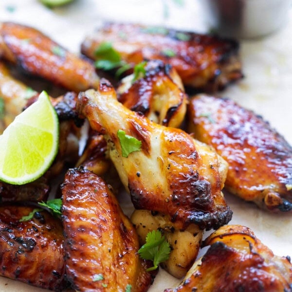 Sweet chili chicken wings served with Thai sweet chili sauce and fresh lime wedges.