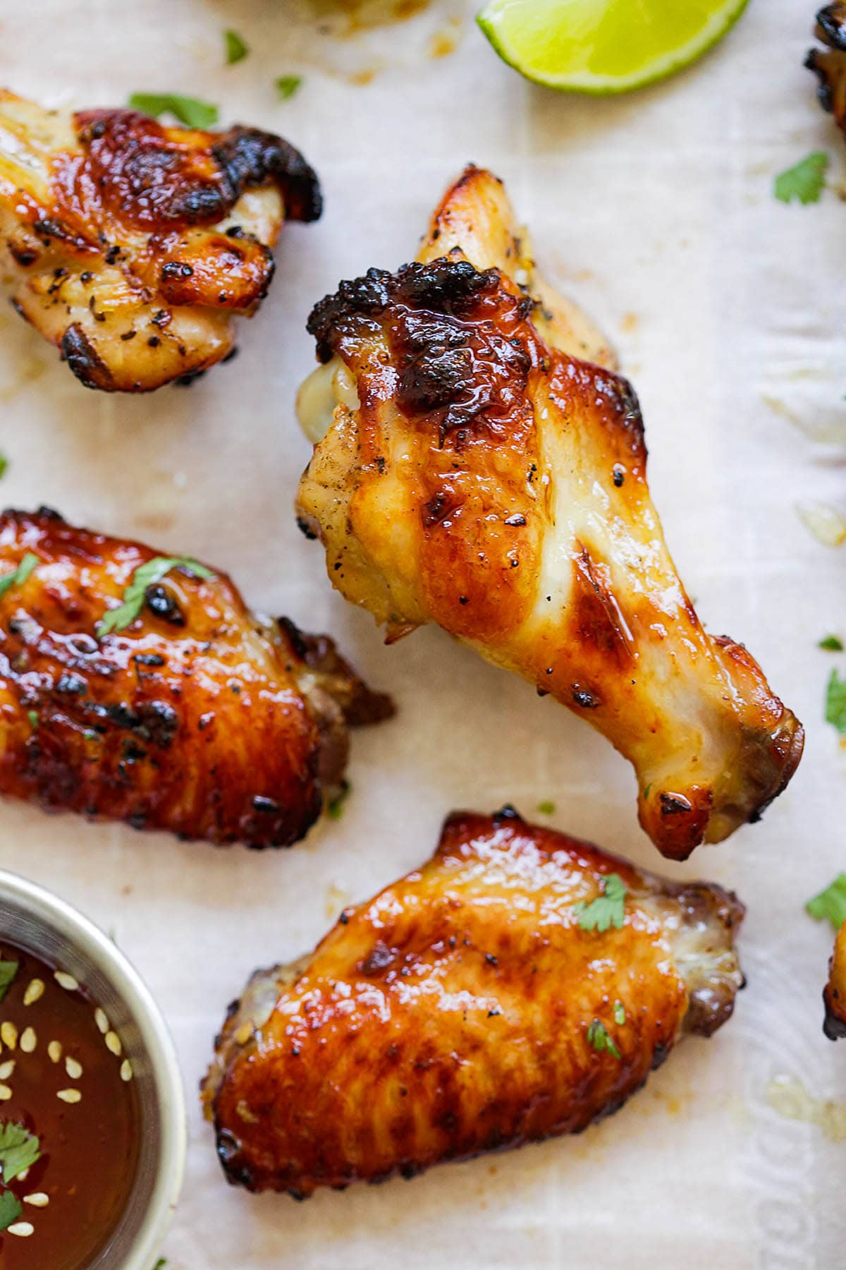 Sticky, golden Thai sweet chili chicken wings garnished with fresh cilantro.