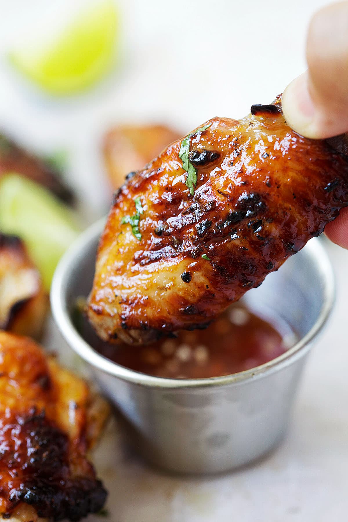 Grilled sweet chili chicken wings with charred skin, perfect for BBQ season.