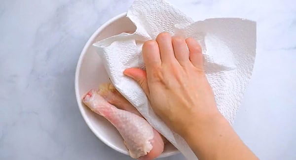 Chicken legs patted dry with a paper towel.