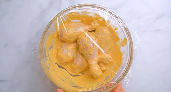 Chicken legs coated with tandoori marinade.