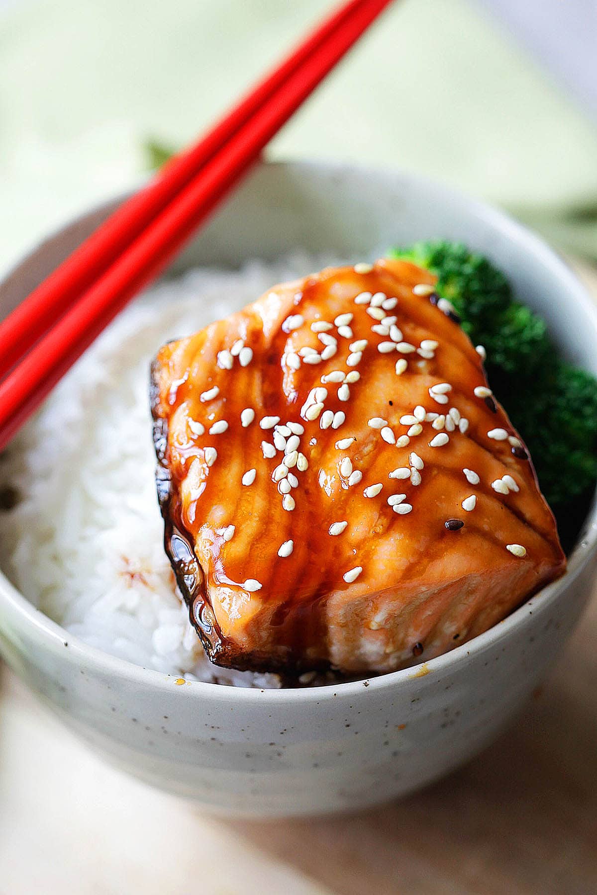 Japanese salmon teriyaki served over rice and topped with sesame seeds.