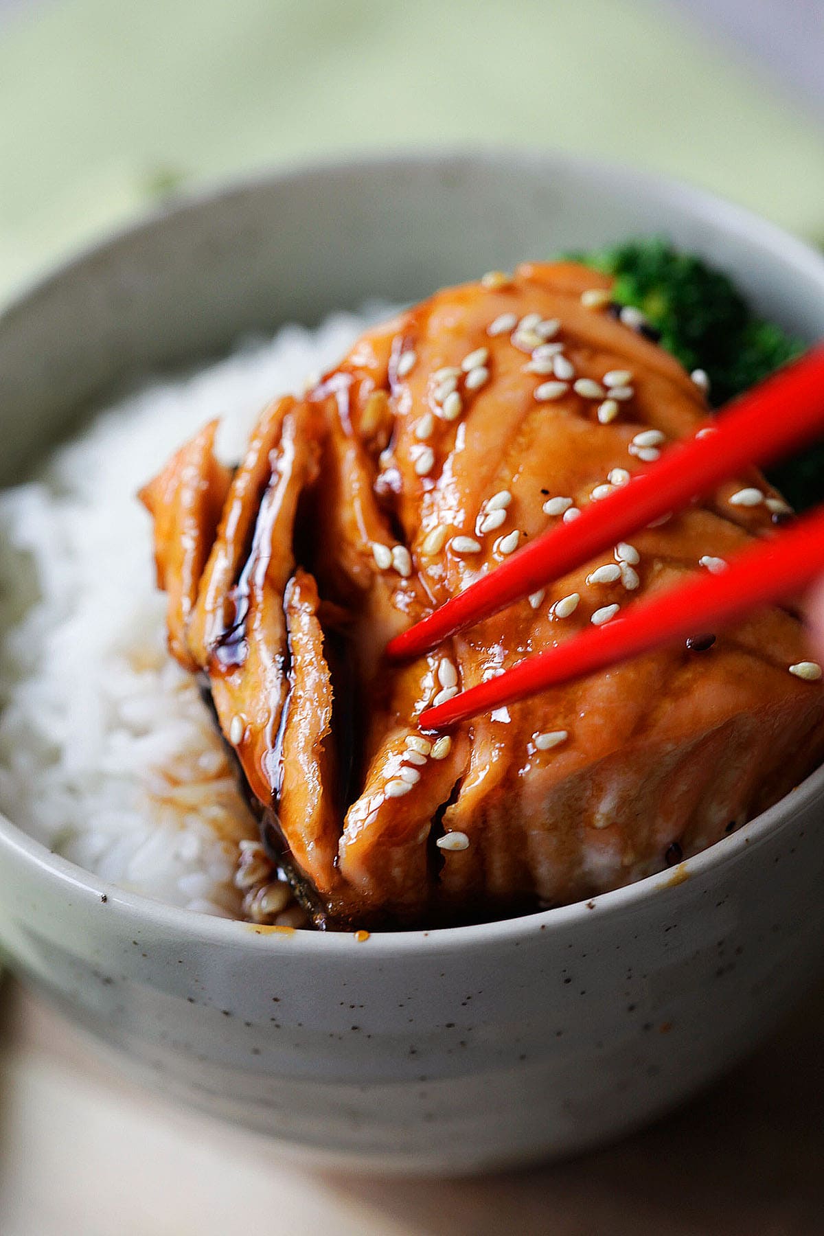 Easy glazed teriyaki salmon served over rice and topped with sesame seeds.