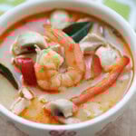 Tom Kha soup with chicken and shrimp in a creamy coconut broth served in a bowl.