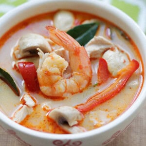 Tom Kha soup with chicken and shrimp in a creamy coconut broth served in a bowl.