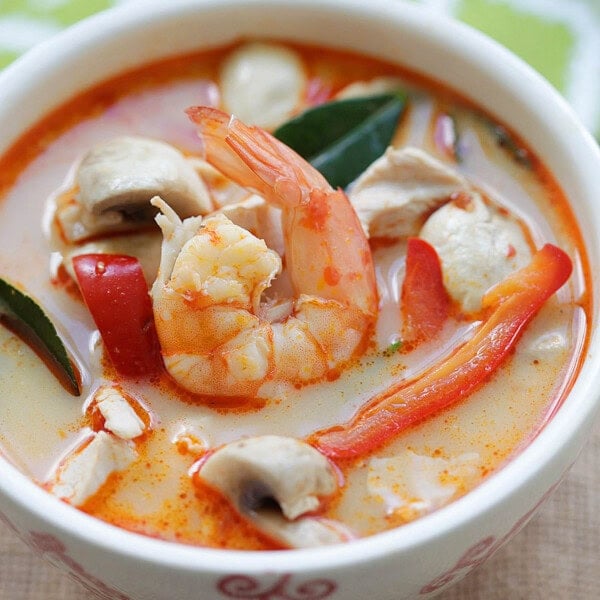 Tom Kha soup with chicken and shrimp in a creamy coconut broth served in a bowl.