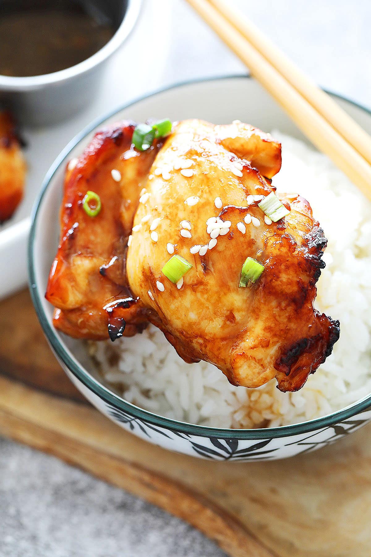 Air fryer teriyaki chicken served over a bowl of steamed rice.