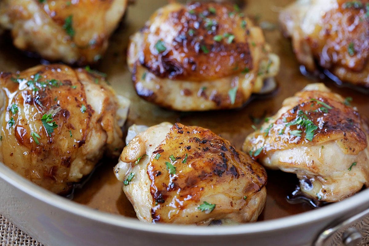 Juicy balsamic and honey chicken coated in a shiny glaze, garnished with parsley.