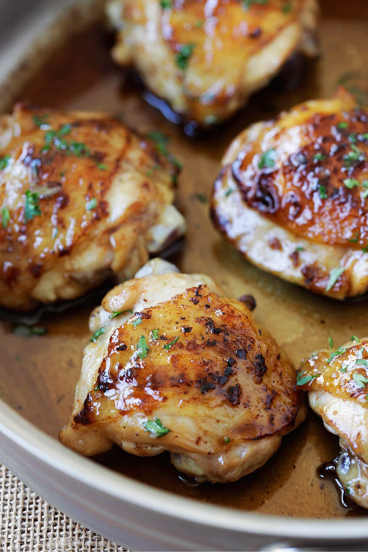 Honey balsamic chicken thighs in a skillet.