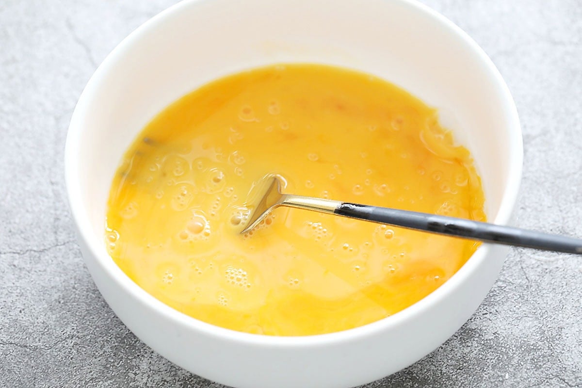 Beaten egg in a bowl.