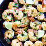 Cilantro lime shrimp recipe cooked in a cast-iron skillet with garlic, butter, and fresh lime.