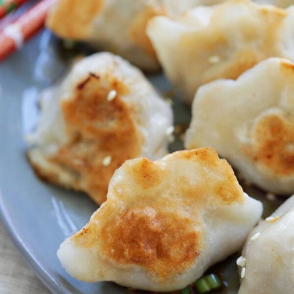 Chinese style pan fried dumplings served on a plate.