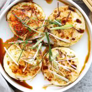 Ginger soy eggs topped with crispy ginger strips and scallions.