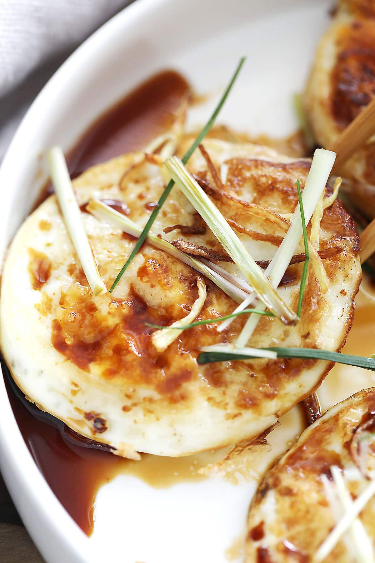 Ginger soy egg drizzled with savory soy sauce and finished with scallions.