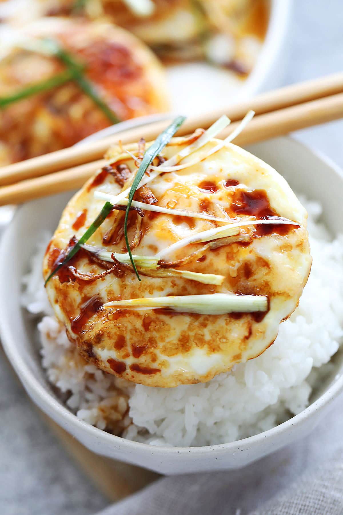 Bowl of steamed rice topped with ginger soy egg.