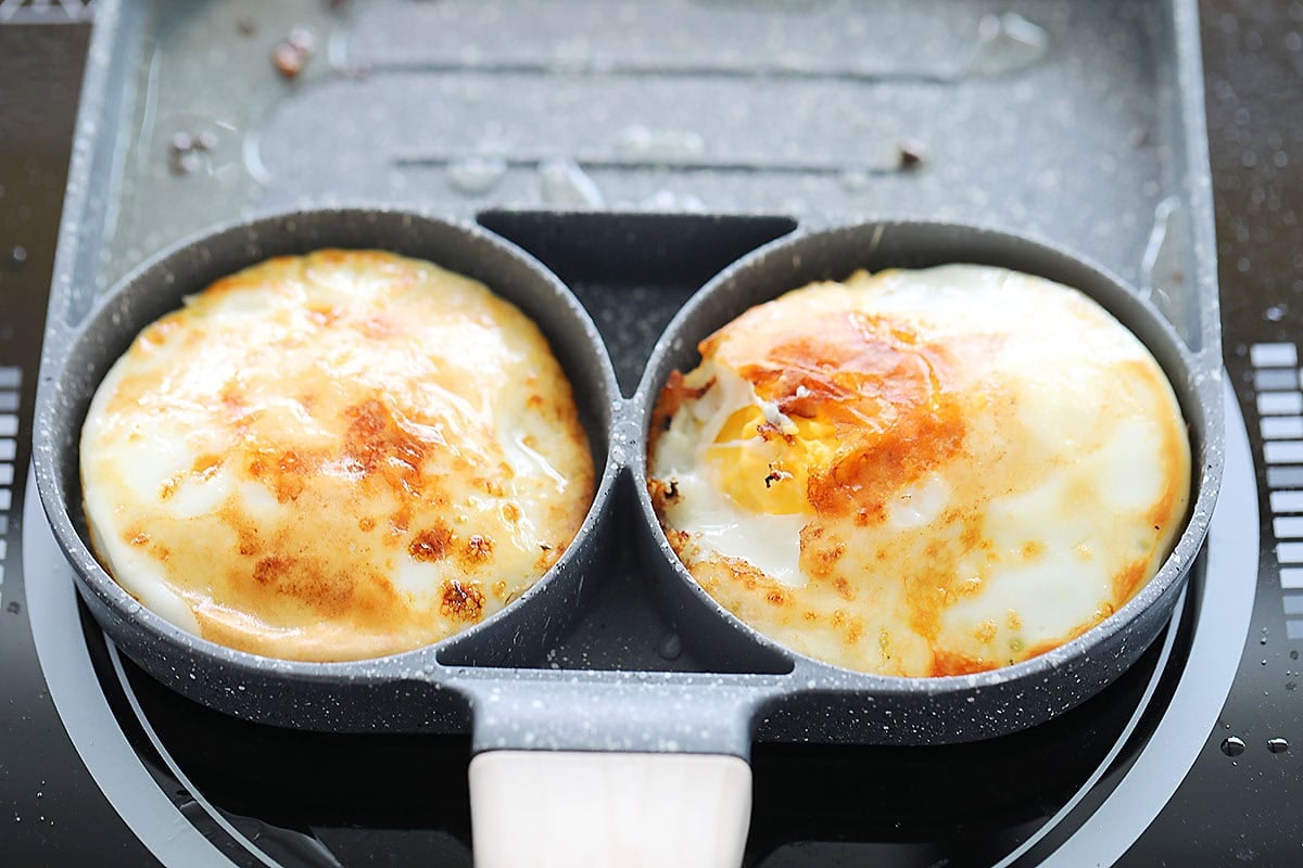 Eggs with golden edges and set whites in a hybrid pan.
