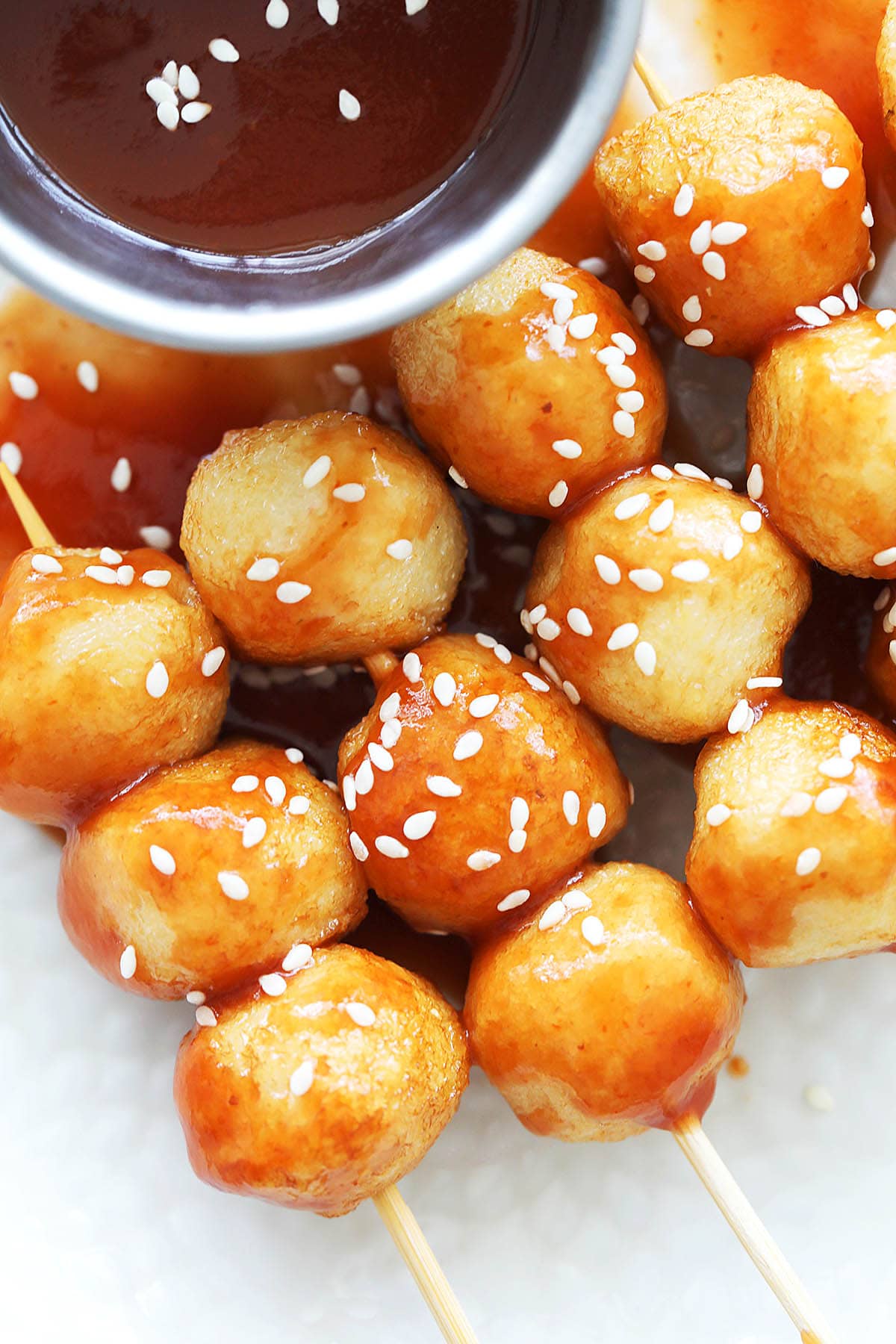 Sweet and sour fish ball garnished with sesame seeds.