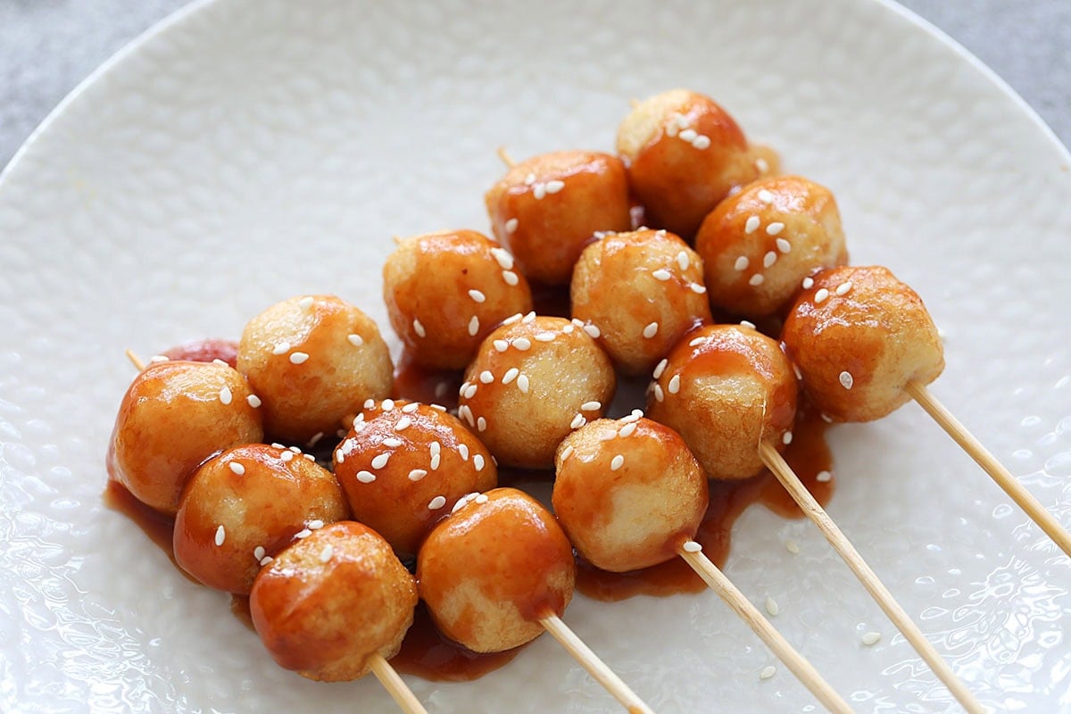 Sweet and sour fish ball sprinkled with sesame seeds.