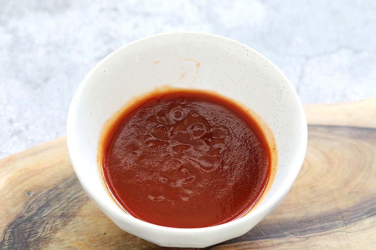 Freshly made sweet and sour sauce served in a small bowl.