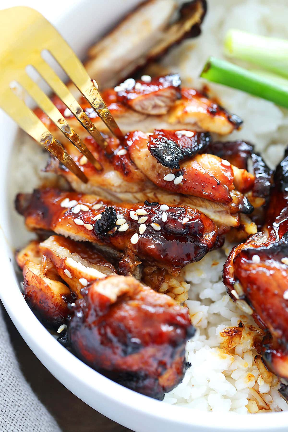 Air fryer Chinese char siu chicken thighs poked with a fork.