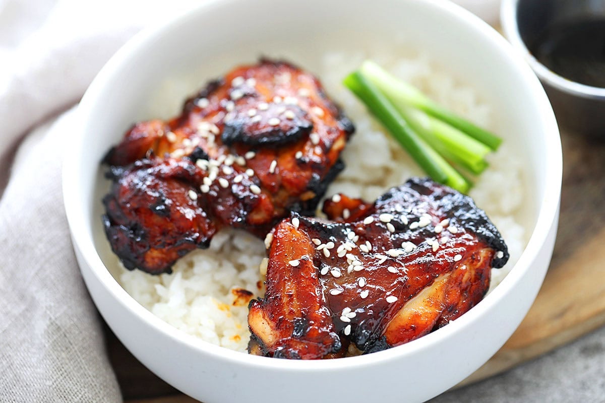 Air fryer Chinese BBQ chicken garnished with sesame seeds.