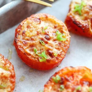 Air fryer roasted tomatoes topped with Parmesan cheese.