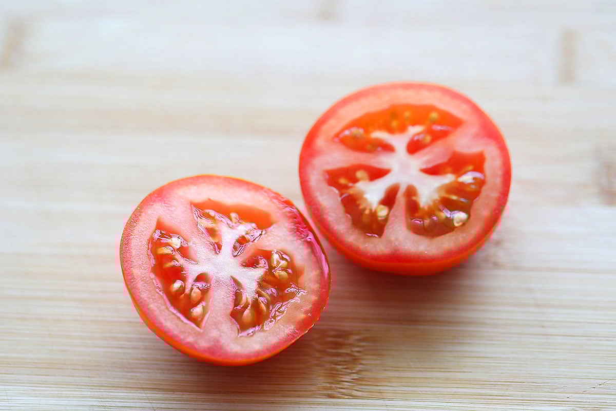 Tomato halves on a cutting board.