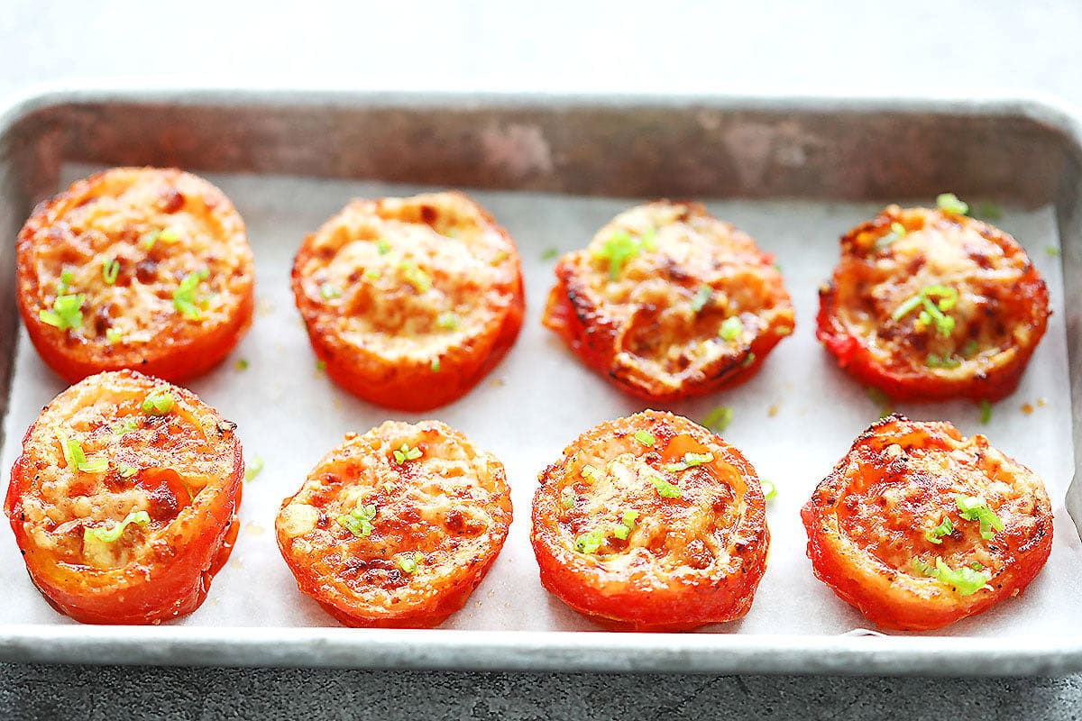 Air fryer roasted tomatoes with Parmesan cheese served on a tray.