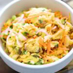 Chinese scrambled eggs with carrots, onions, and scallions served in a bowl.