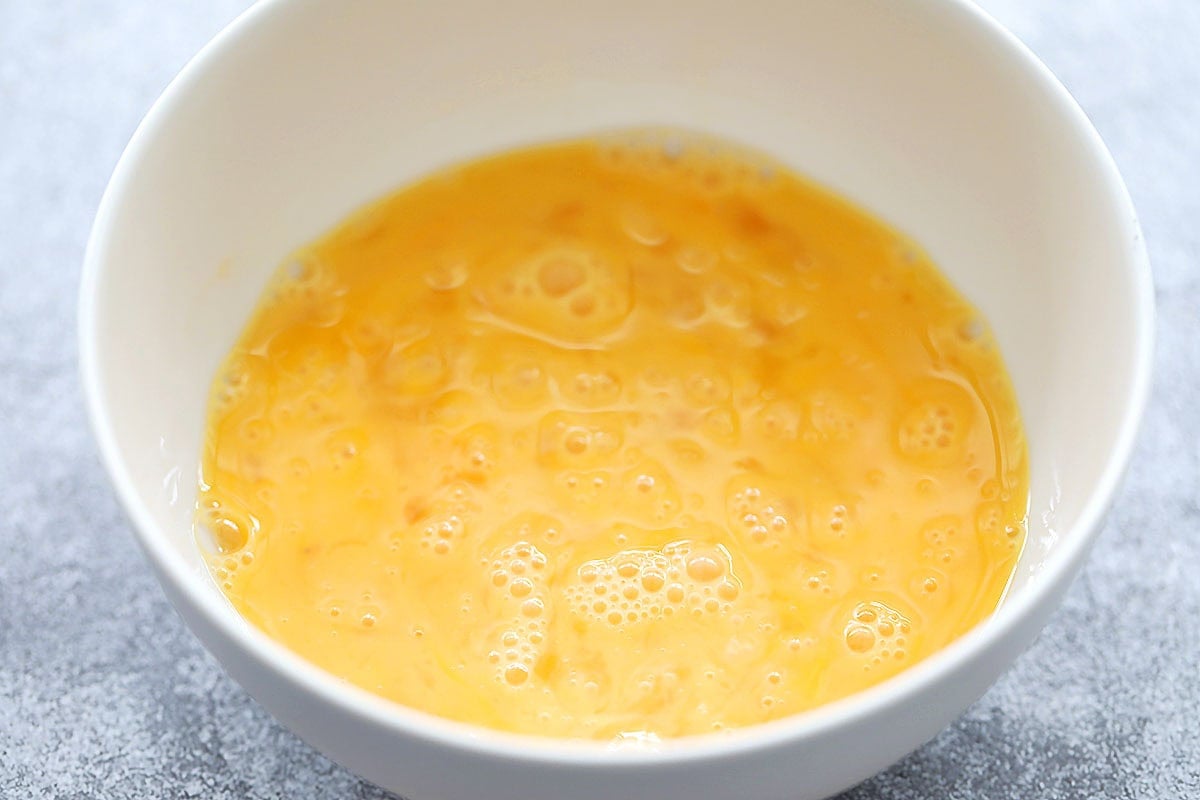 Beaten eggs in a bowl.