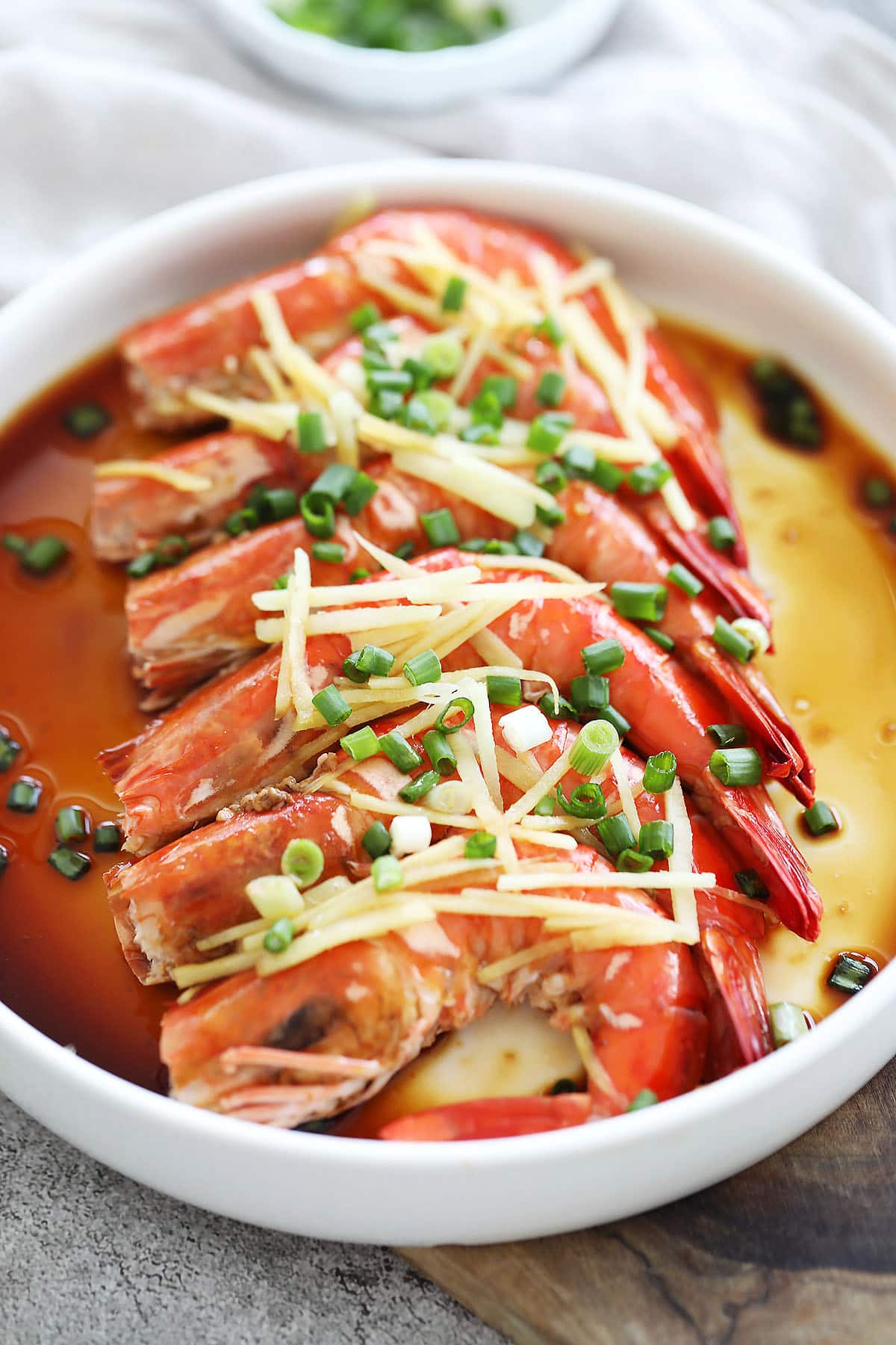 Cantonese steamed shrimp with ginger slices and scallions.