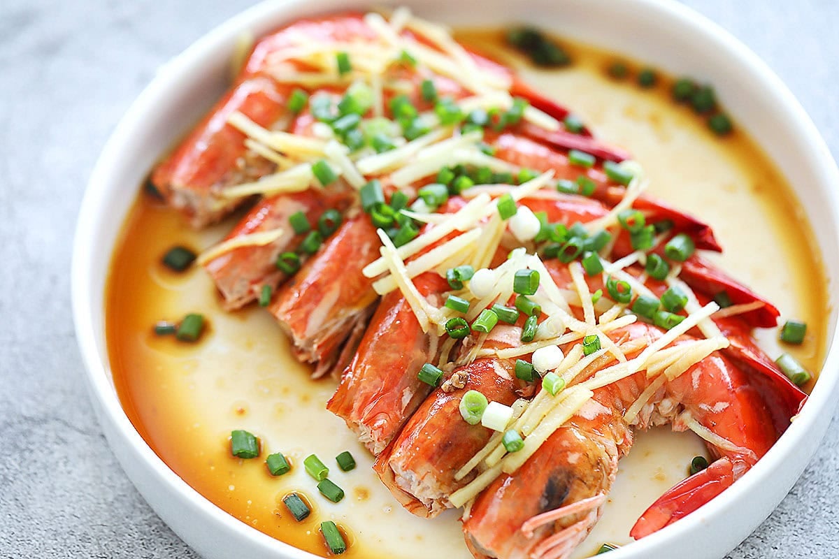 Chinese steamed shrimp garnished with ginger and scallions.
