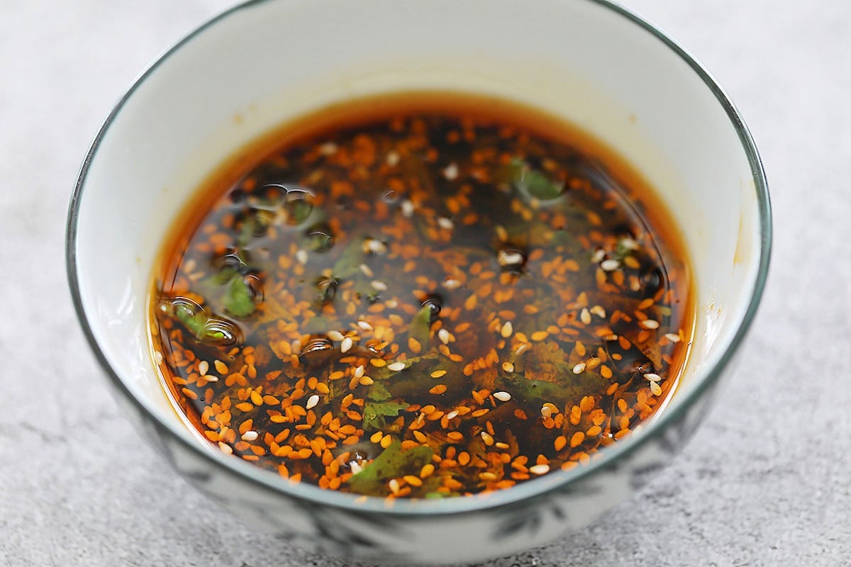 Dumpling dipping sauce made with homemade chili oil in a bowl.