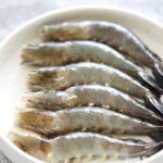 Cleaned shrimp arranged on a plate.