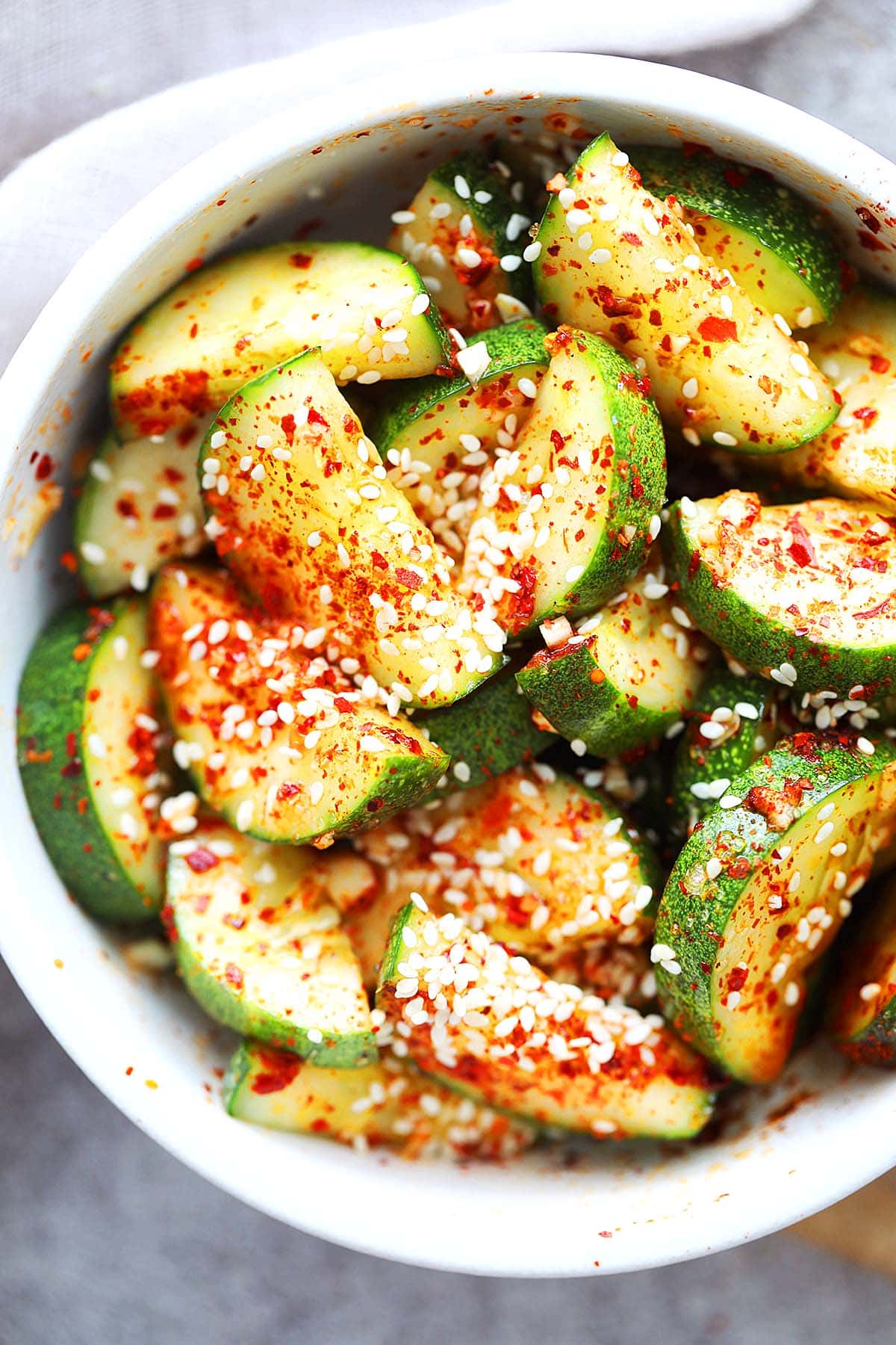 Easy and spicy Asian cucumber salad topped with sesame seeds.
