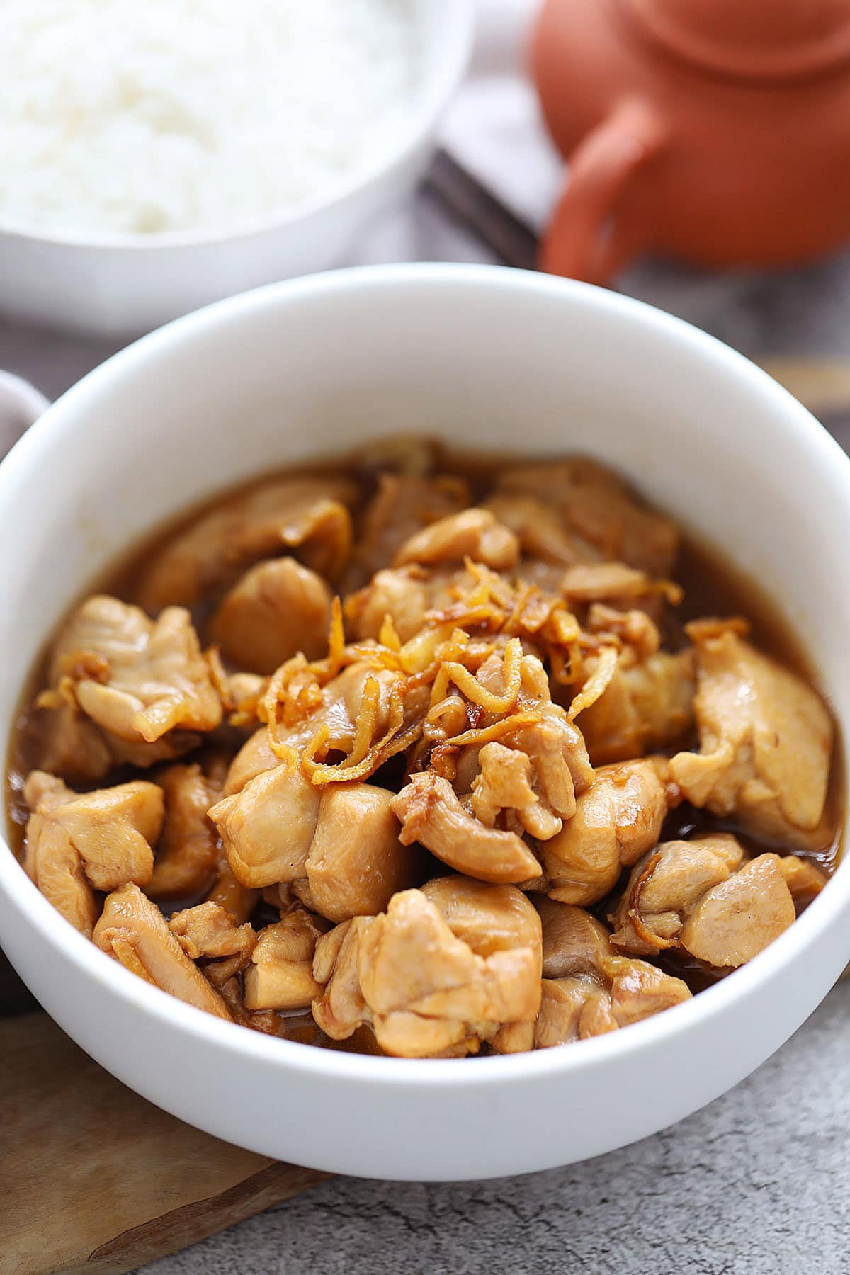 Sesame oil chicken with ginger strips in a bowl.