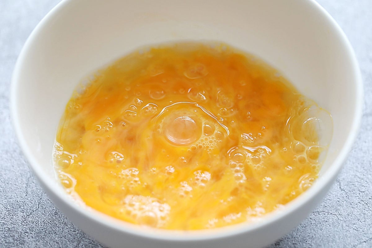 Lightly beaten eggs in a bowl.