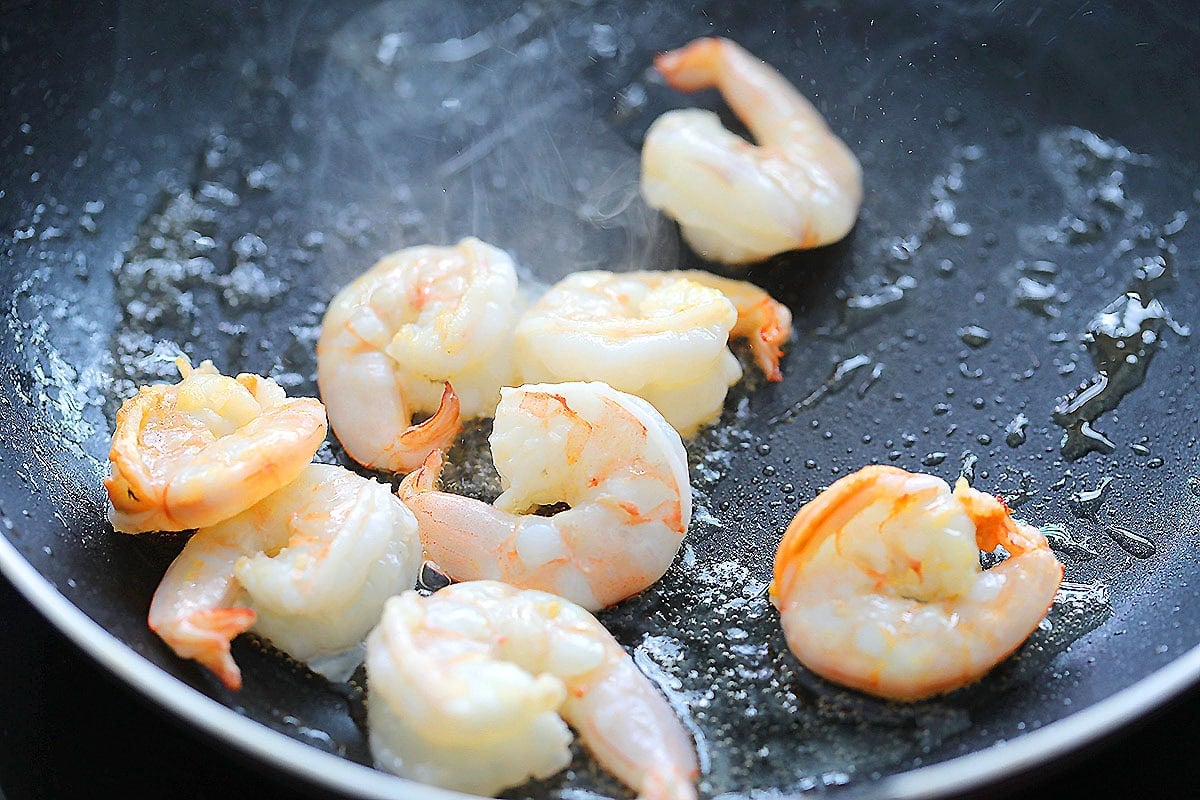 Cooked shrimp in a skillet.