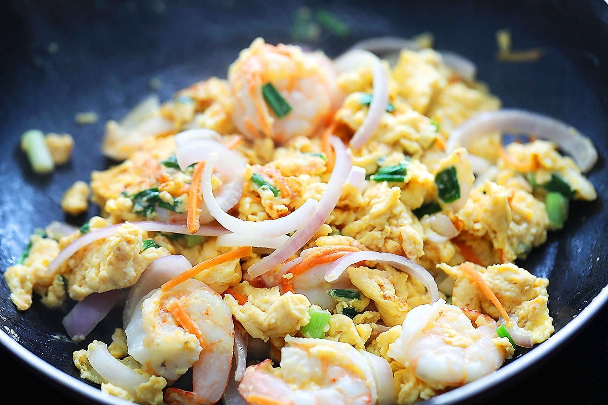 Fluffy and tender shrimp omelette in a skillet.