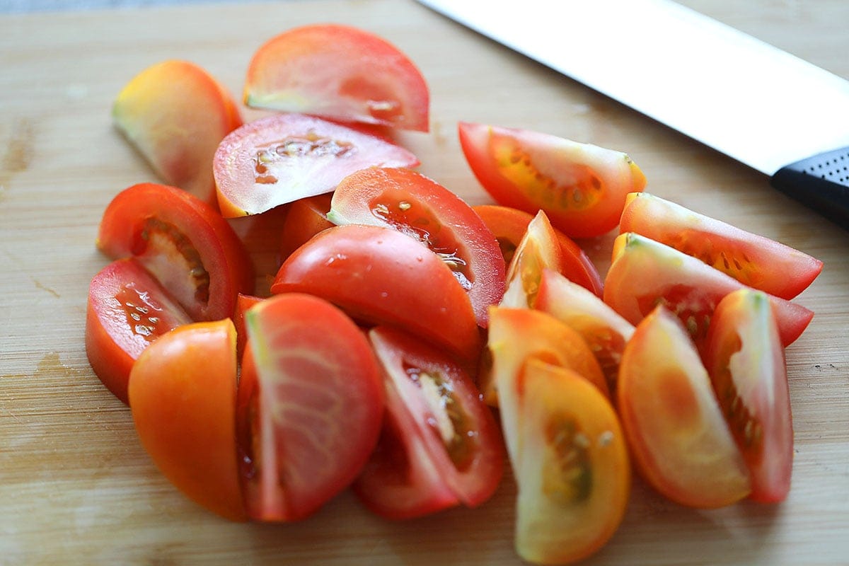 Tomato wedges on a chopping board.