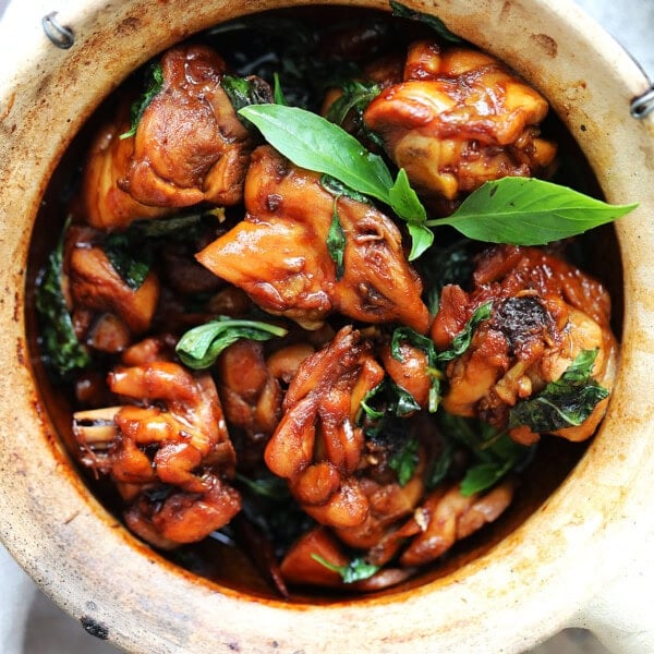 Authentic Taiwanese Three Cup Chicken cooked with sesame oil, soy sauce, Shaoxing wine, garlic, ginger, and fresh basil.