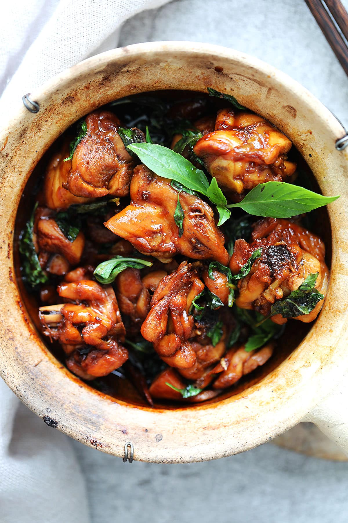 Authentic Taiwanese Three Cup Chicken cooked with sesame oil, soy sauce, Shaoxing wine, garlic, ginger, and fresh basil.