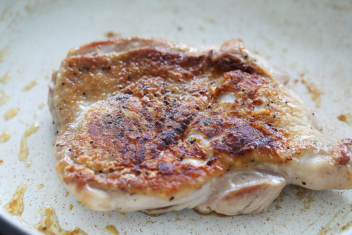 Golden brown pan-fried chicken cutlet.