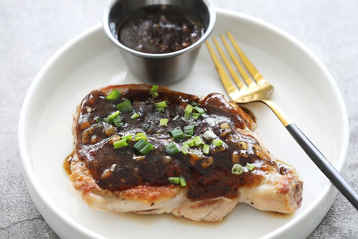 Pan fried black pepper chicken garnished with scallions.